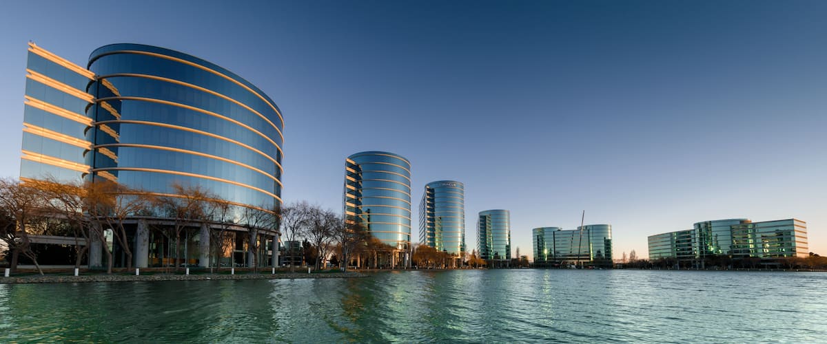 Modern buildings by a calm river.
