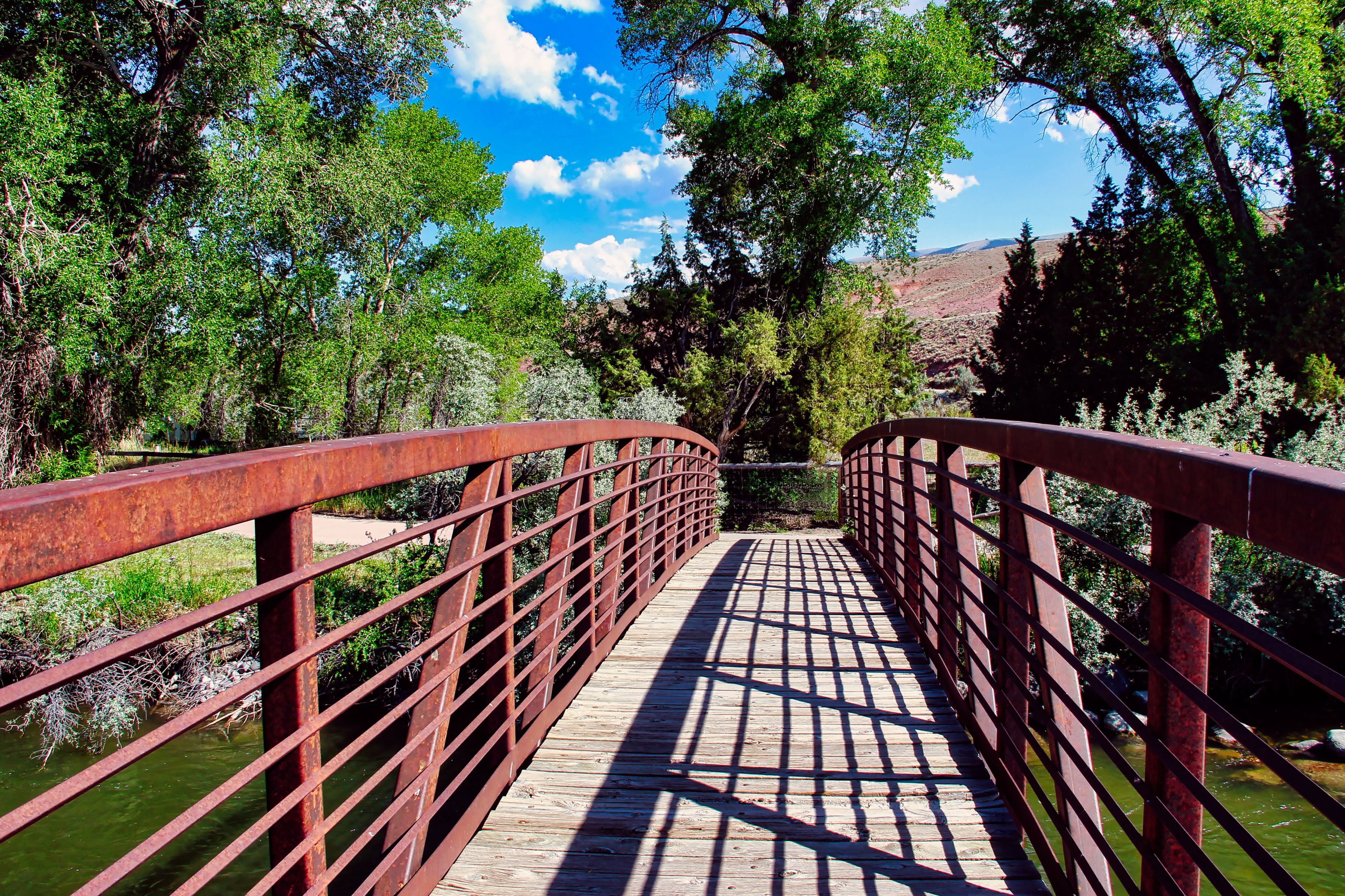 Summer Day Walking on the Red Bridge over the Wind River at Dubois Town Park in Western Wyoming.