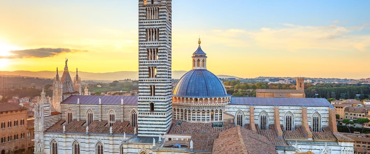 Siena aerial sunset panoramic view. Cathedral Duomo landmark. Tuscany, Italy.