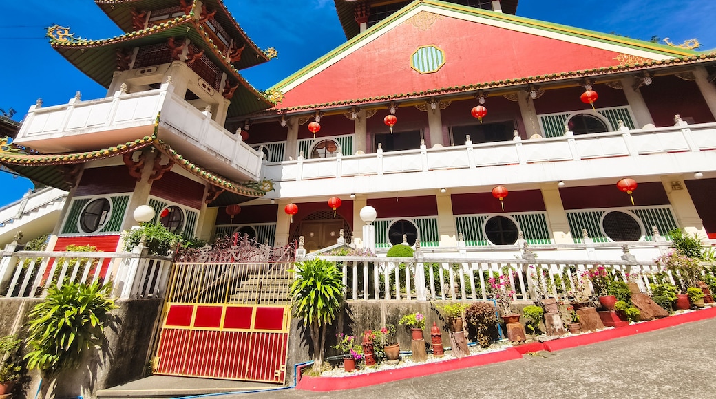 A traditional multi-tiered building with ornate roofs and red lanterns.