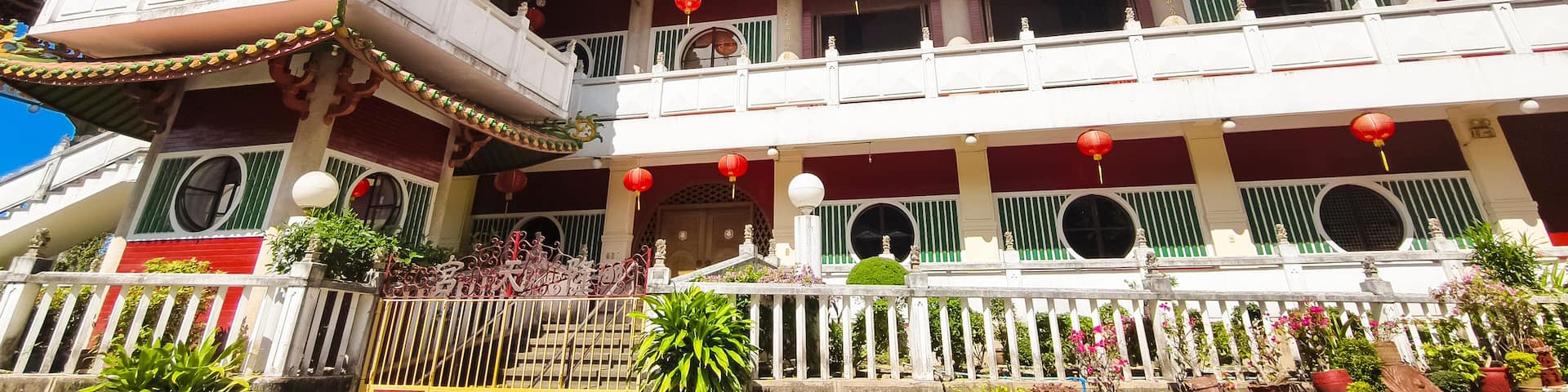 A traditional multi-tiered building with ornate roofs and red lanterns.