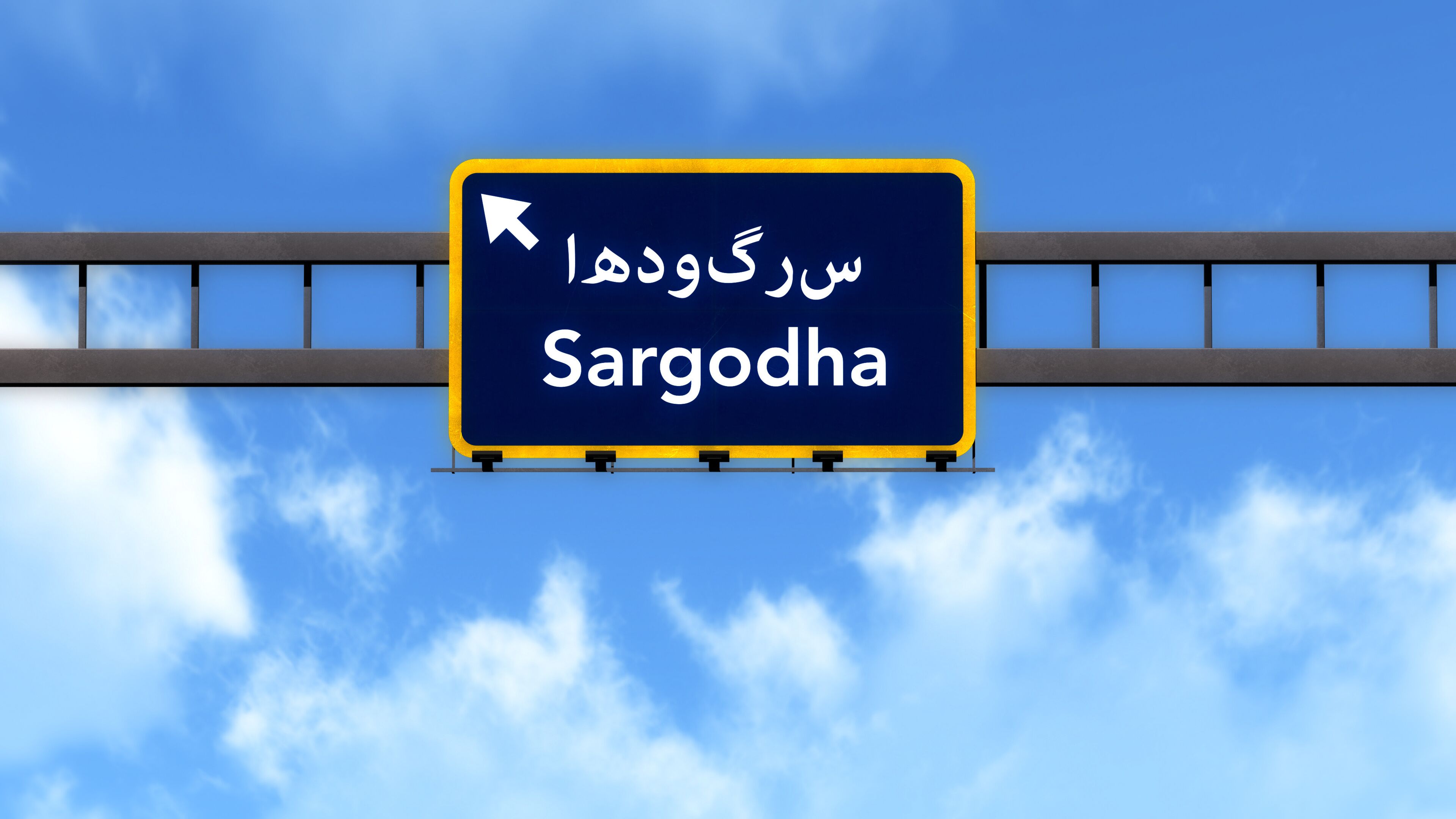 A road sign with the text 'Sargodha' and an arrow pointing left.