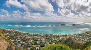 Panoramic view of famous Lanikai Beach and Kailua Bay on the island of Oahu, Hawaii, USA with Mokulua Islands or Twin Islands against blue sky with clouds