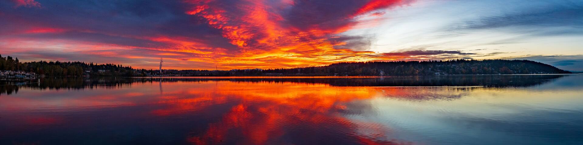A fiery red and orange sky and reflection on the waters of Lake Washington