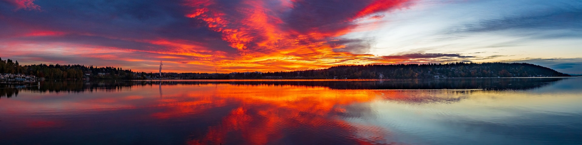 A fiery red and orange sky and reflection on the waters of Lake Washington