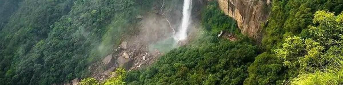 A waterfall cascading down a lush, green mountain.