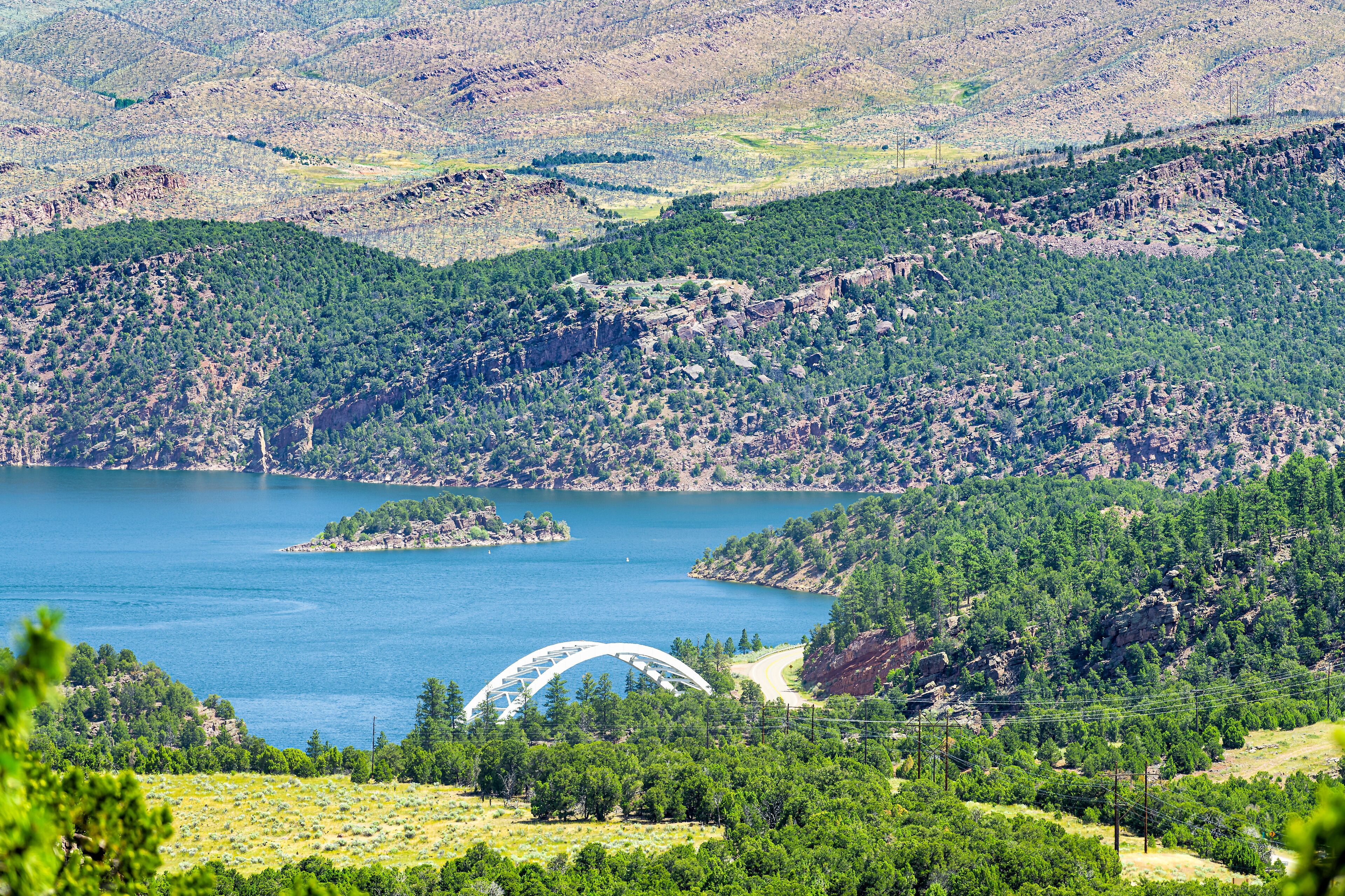 Dutch John, USA with Flaming Gorge Reservoir Bridge white color and blue lake river in summer in Utah National Park above high angle view