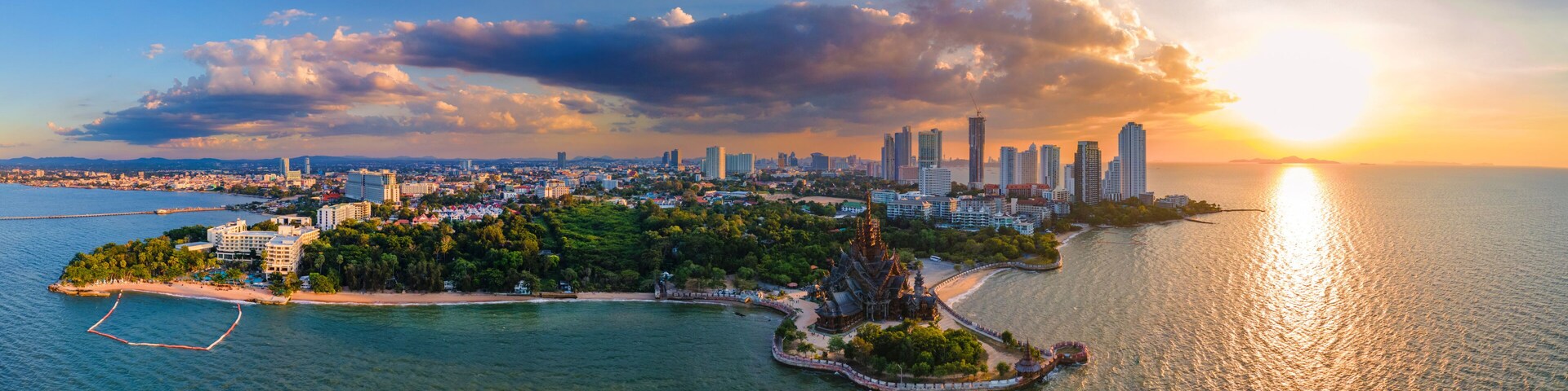 A coastal cityscape with a prominent temple on an island, surrounded by water.