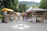 A market with art stalls and a star-shaped pavement design.