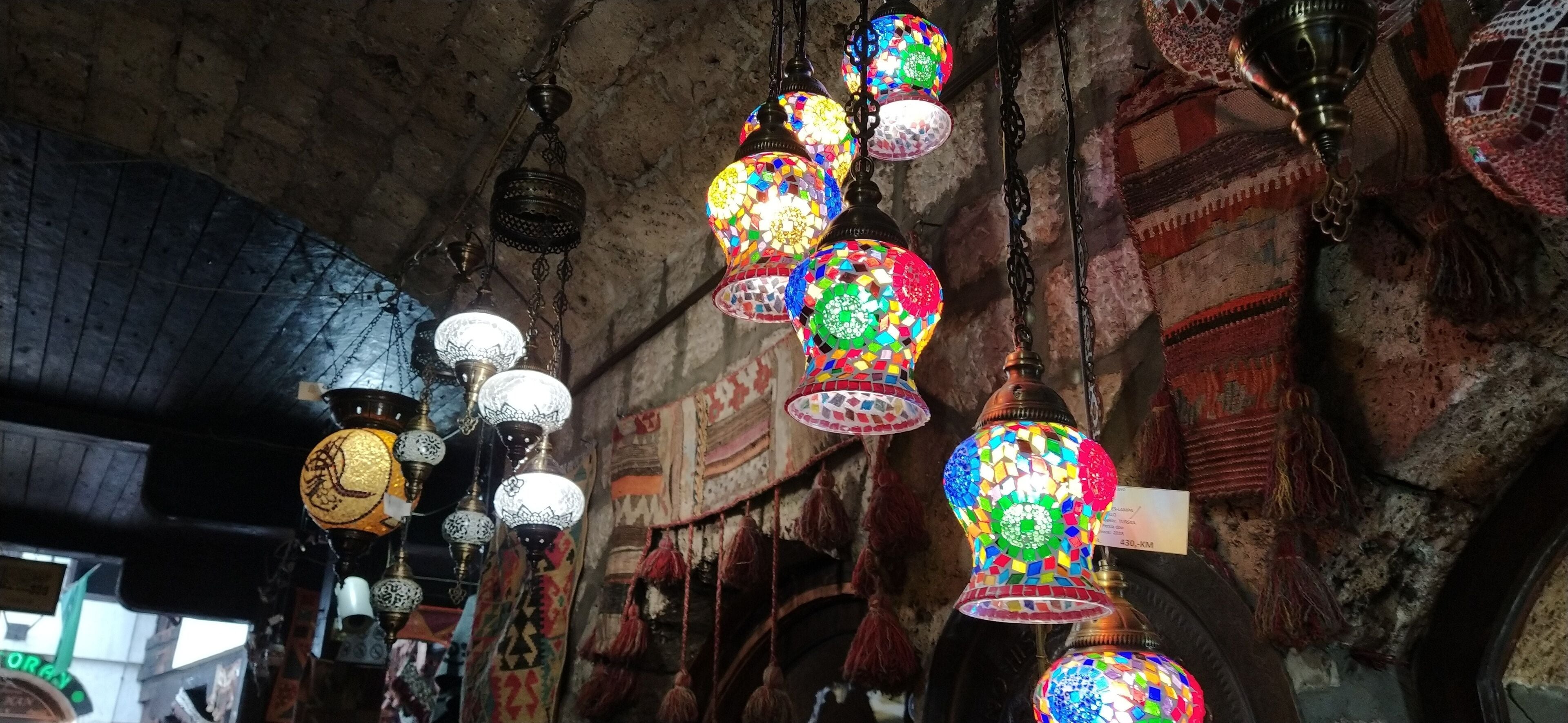 Traditional vintage Turkish lamps over light background in the night. Colored glass lamps and shades on the market in Sarajevo, Bosnia and Herzegovina. Sale of souvenirs in the market. Euro-trip