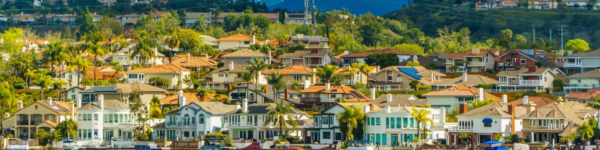 Lake Mission Viejo with snow capped Santa Ana Mountains in the distance, after epic snowstorm in Southern California