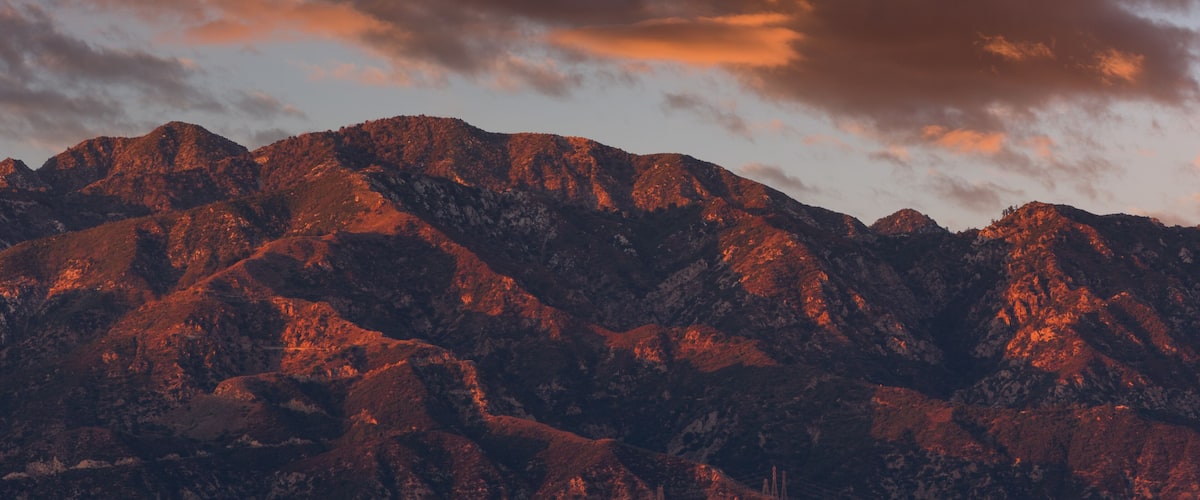Rugged mountains with a sunset sky.