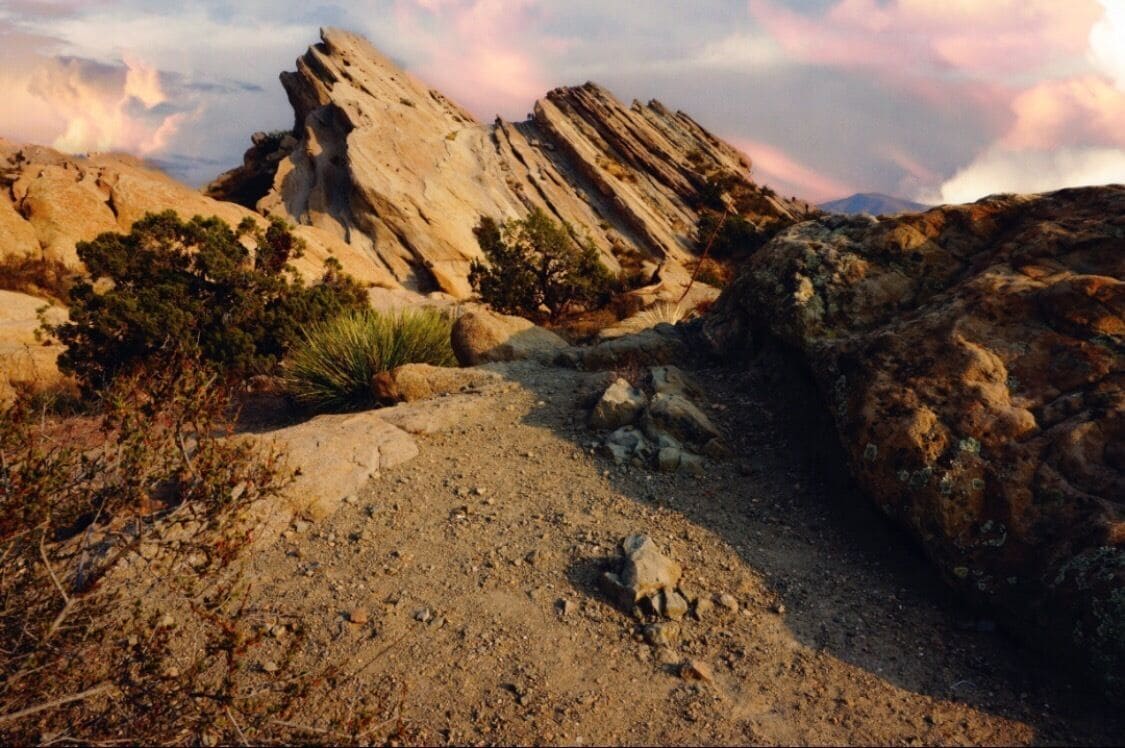 A rocky terrain with a prominent cliff and sparse vegetation.