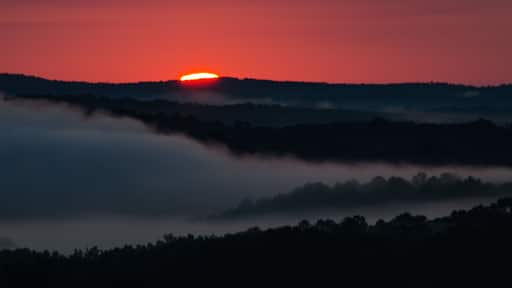 The start of a colorful sunrise over the foggy valleys near Heflin, Alabama, USA
