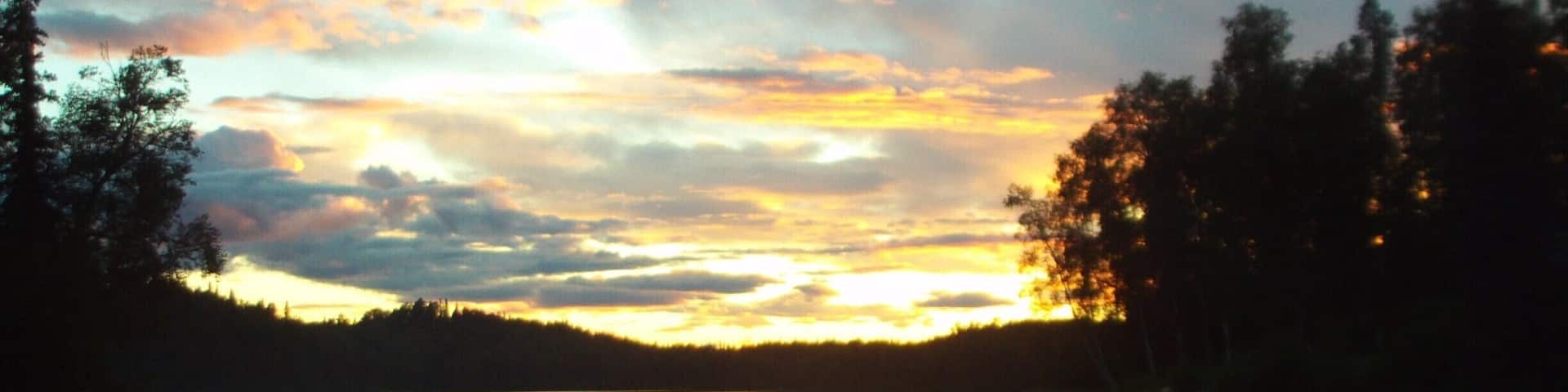 A vivid sunset over Lake Bulchitna caps the end of a fantastic day fishing and hiking.