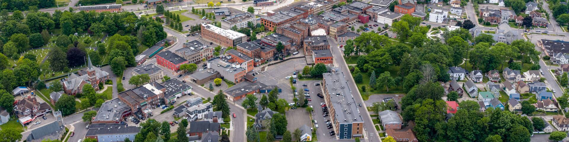 Oneonta, NY, USA - June 7, 2026: Late afternoon spring aerial photo of downtown, business district, Oneonta, NY on an overcast day.