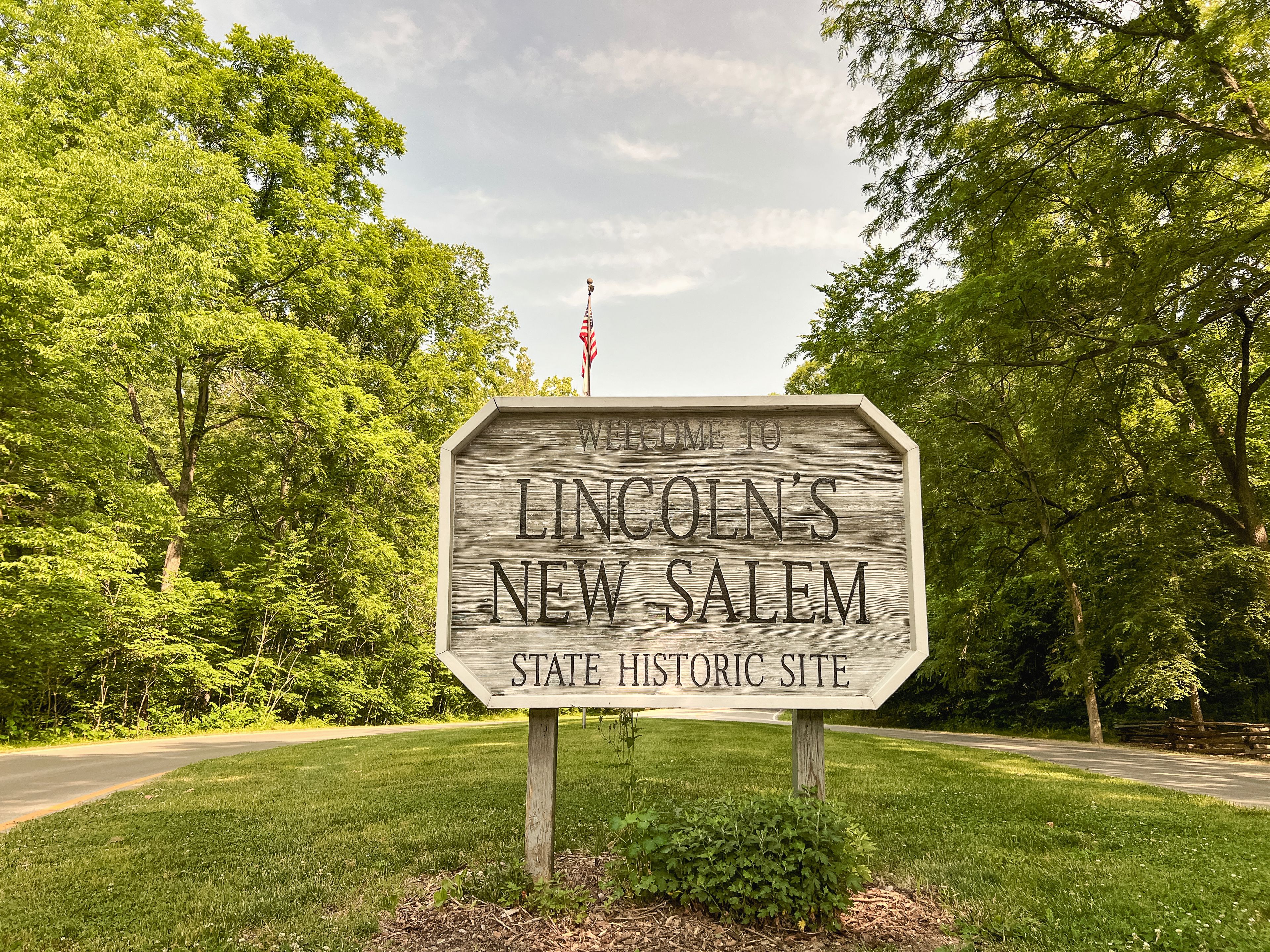 Rectangular wooden sign at the entrance to Lincoln's New Salem Historic Site. A reconstruction of the former village of New Salem in Menard County, Illinois, where Abraham Lincoln lived 1831 to 1837.
