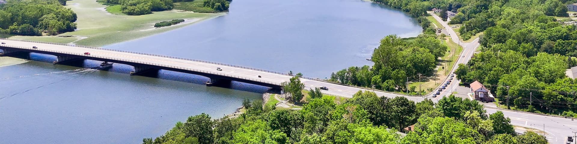 Aerial view of the Route 9 Bridge spanning the Mohawk River at Crescent, NY, blue sky, clouds, lush foliage