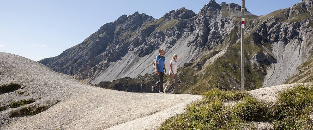 St. Moritz showing a coastal town and hiking or walking as well as a couple