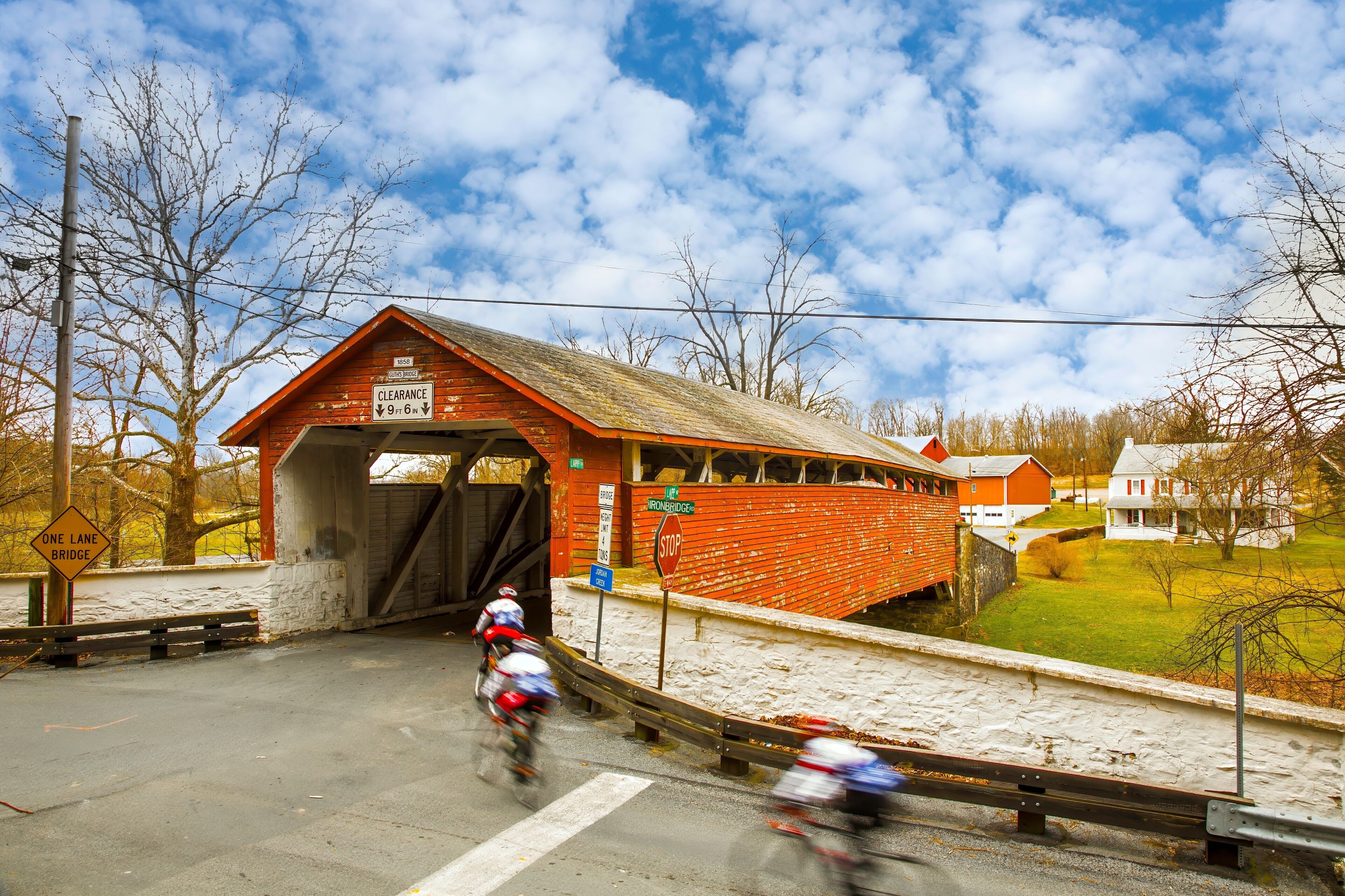 Guth's Covered Bridge in Whitehall PA, bicycle riders blurred to show motion