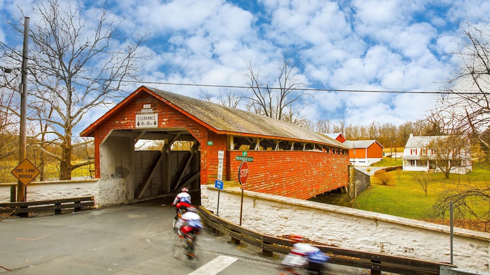 Guth's Covered Bridge in Whitehall PA, bicycle riders blurred to show motion