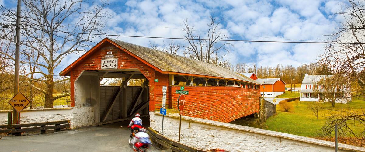 Guth's Covered Bridge in Whitehall PA, bicycle riders blurred to show motion