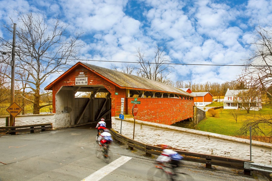 Guth's Covered Bridge in Whitehall PA, bicycle riders blurred to show motion