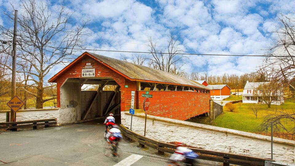 Guth's Covered Bridge in Whitehall PA, bicycle riders blurred to show motion