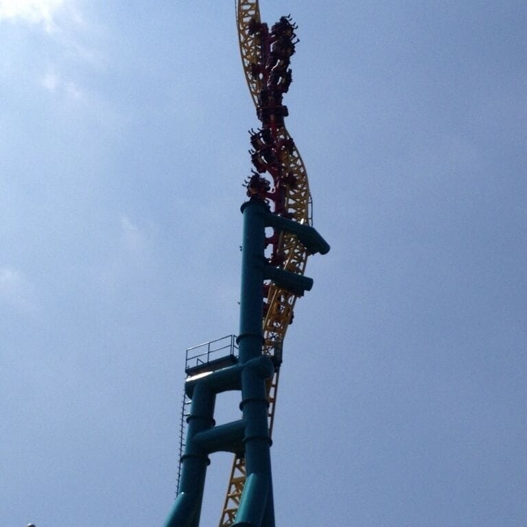A roller coaster with a steep drop and a track that curves to the right.