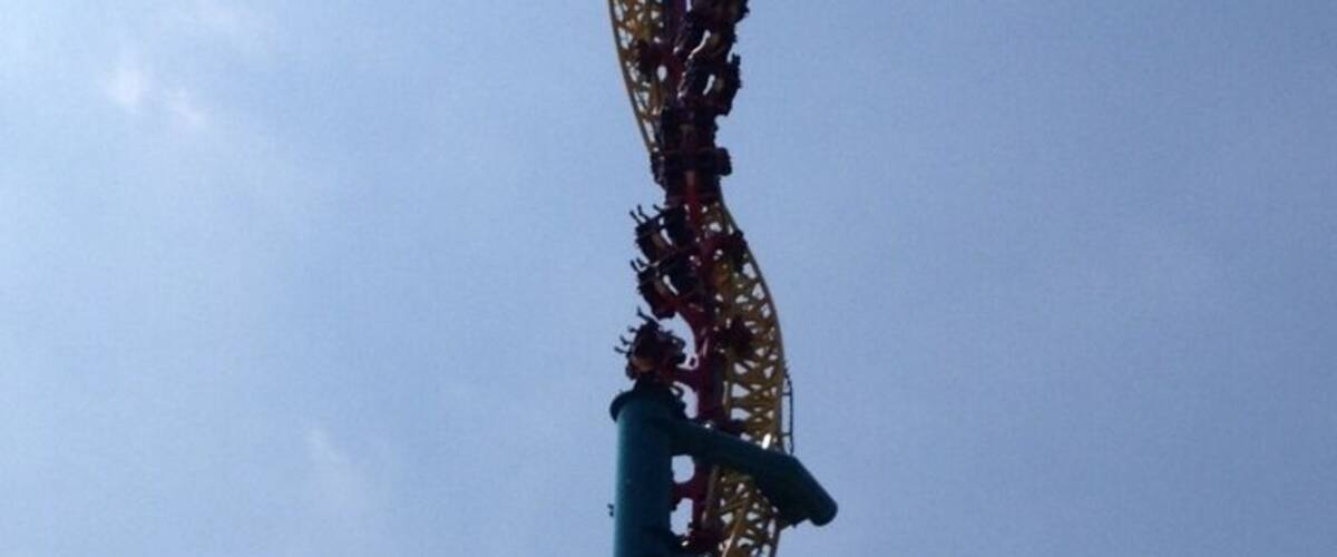 A roller coaster with a steep drop and a track that curves to the right.