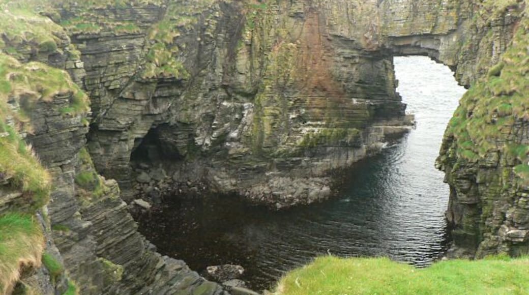 Vat of Kirbuster. The vat is a "gloup" - a partially collapsed sea cave with part of the roof remaining and forming an arch. (The name is sometimes spelt Kirbister. The SNH sign at the nearby car park has both spellings.)