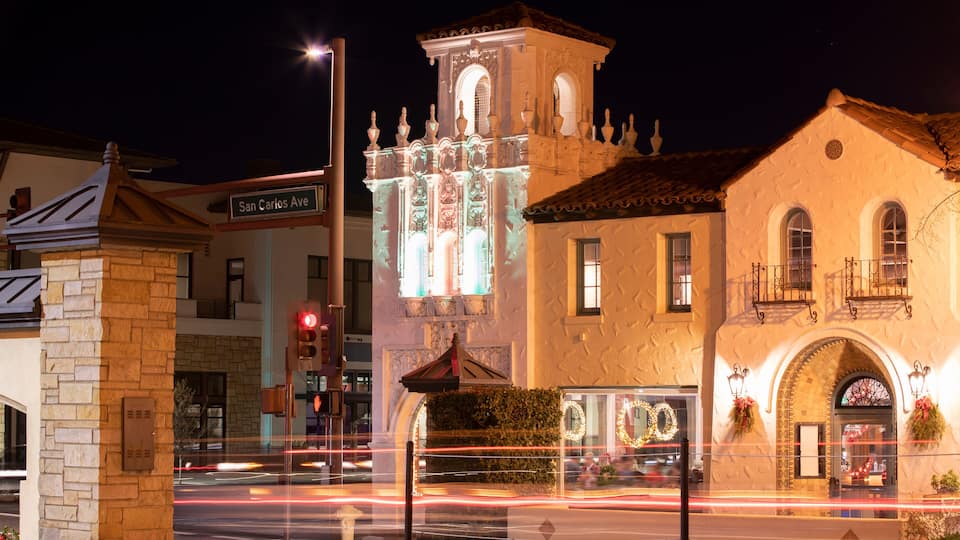 A historic building with ornate architecture and a clock tower, located at the intersection of San Carlos Ave.