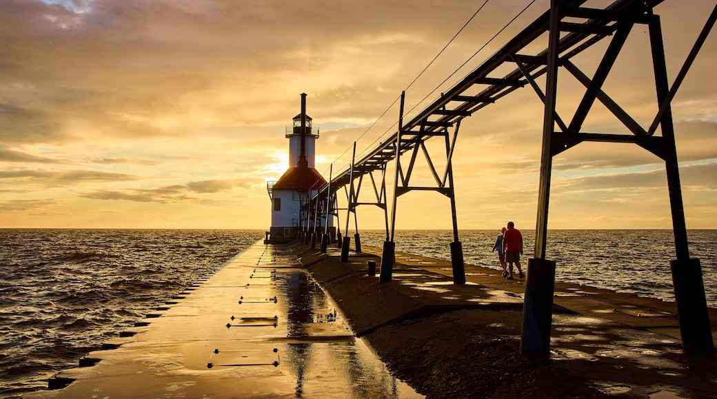 Lighthouse at Sunset with Couple on Pier from Eye-Level Perspective