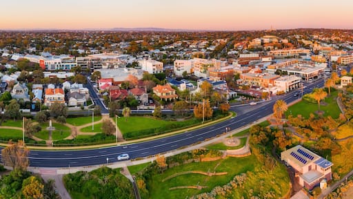 Waterfront property along a batside espalnade in golden lighting