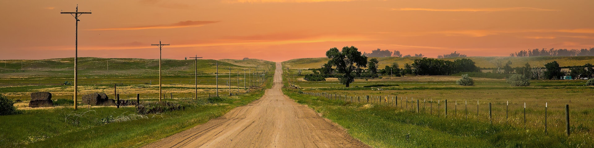 a county gravel road runs through farm land in north eastern Colorado east of Sterling