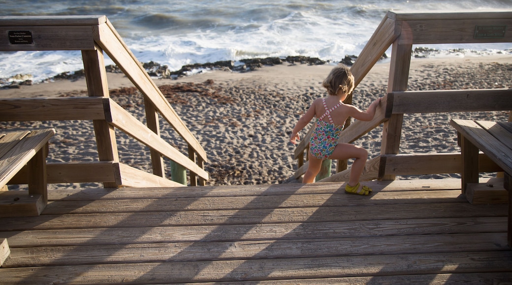 A child climbs down a beach stairway.