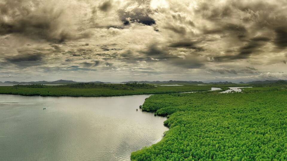 Dark and moody skies over the coastal tropical landscapes of Surigao Del Norte, Mindanao Philippines.