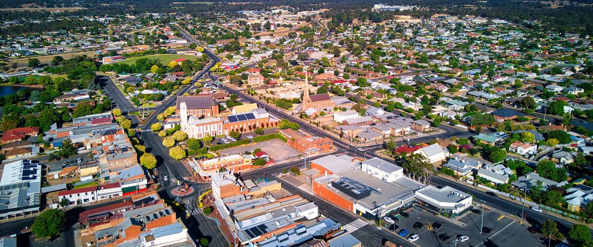 A town with a prominent church, a central roundabout, and a mix of residential and commercial buildings.