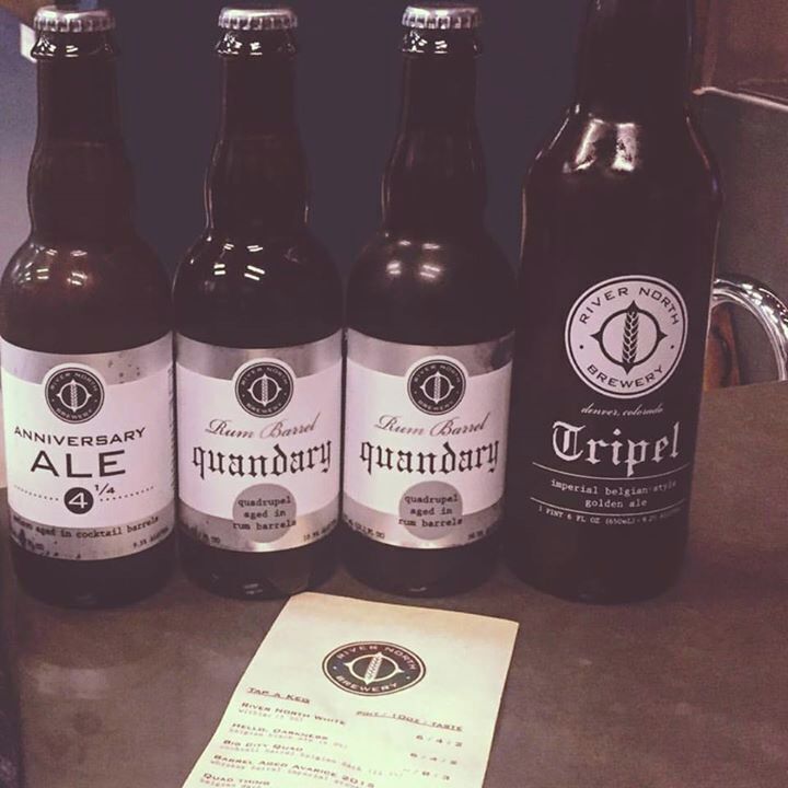 Four bottles of beer with labels, one of which is labeled 'Tripel'.
