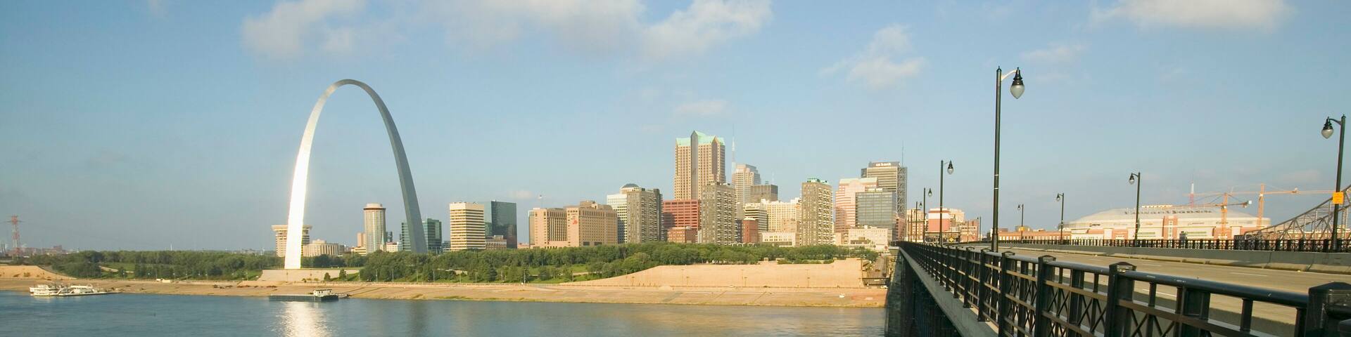 Gateway Arch and skyline of St. Louis, Missouri at sunrise from bridge in East St. Louis, Illinois on the Mississippi River
