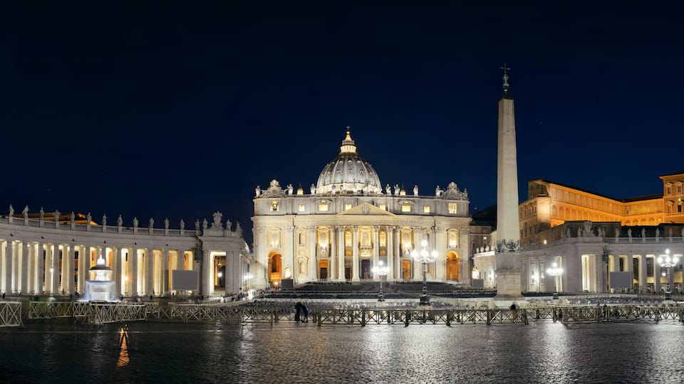 St. Peter's Basilica with its dome and adjacent obelisk, surrounded by a colonnade.