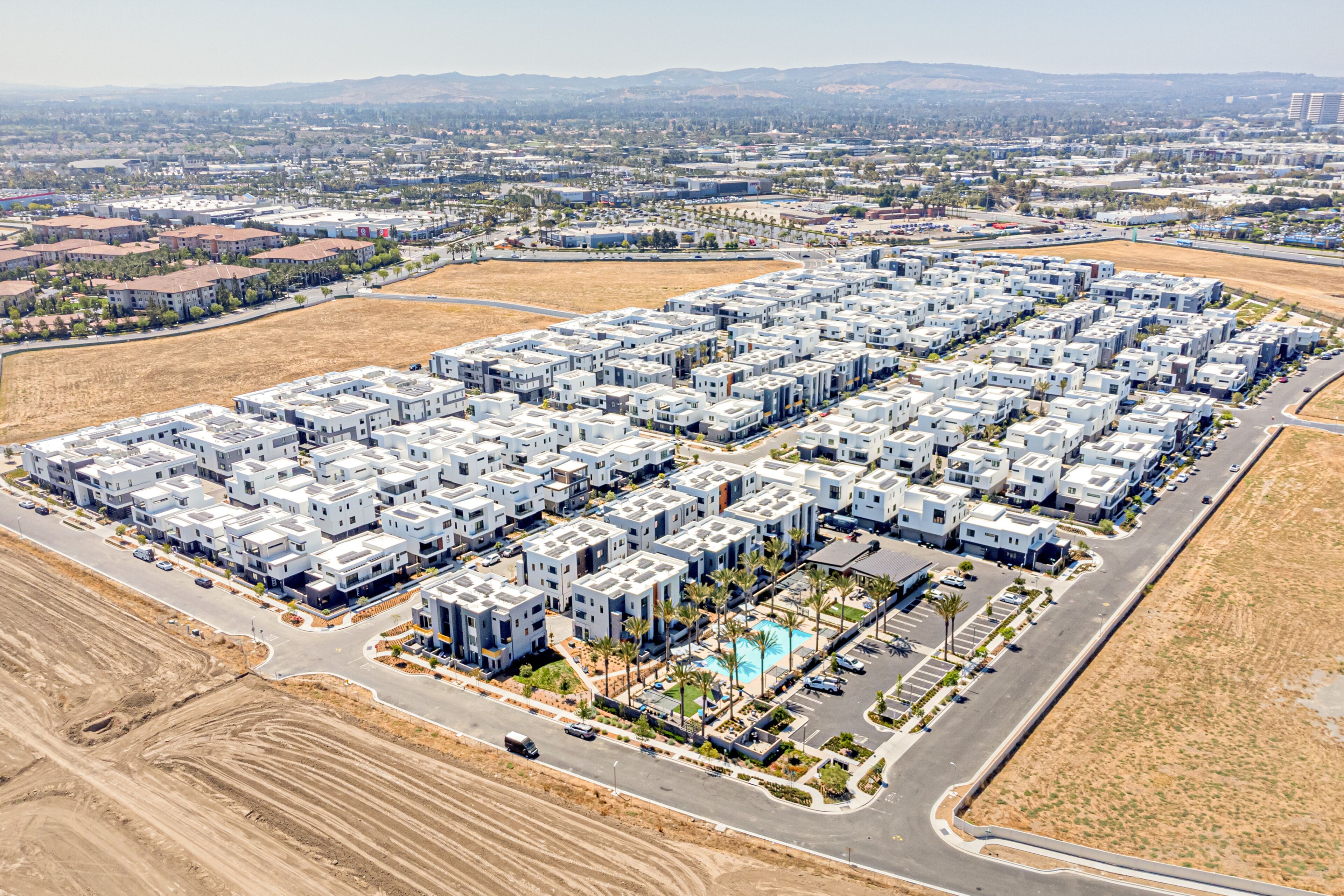 Tustin, California, Orange County - July 30, 2024: Aerial Drone Tustin Irvine View Photo toward Barranca Pkwy, Warner Ave, Red Hill Ave, Tustin Legacy Community with Apartment, House, Home, Town, Stre