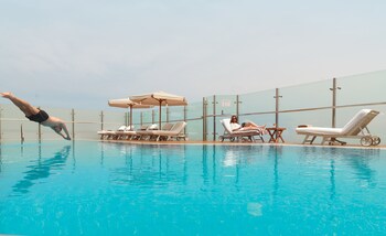 Outdoor pool, open 6:00 AM to 10:00 PM, pool umbrellas, sun loungers
