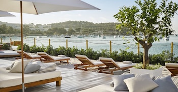 On the beach, white sand, beach cabanas, sun loungers