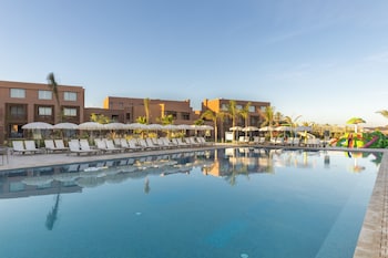 Una piscina al aire libre, sombrillas, tumbonas