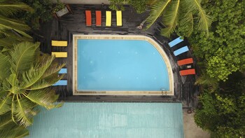 Una piscina al aire libre, tumbonas