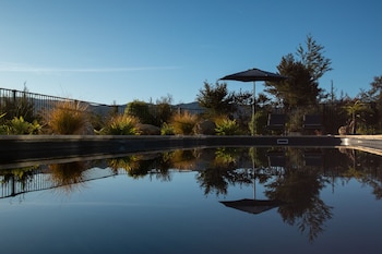 Seasonal outdoor pool, open 8:00 AM to 8:00 PM, pool loungers